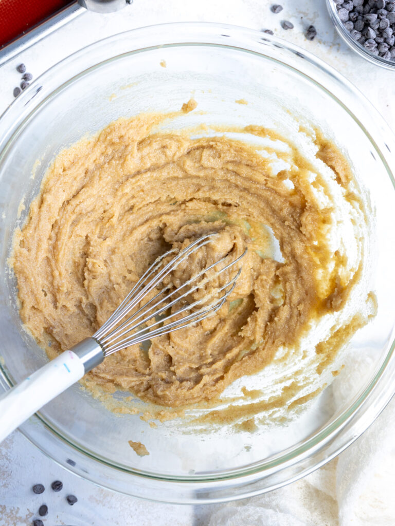 image of brown sugar, granulated sugar, and melted butter being whisked together