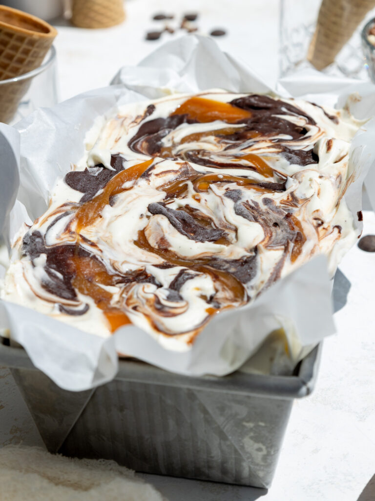 image of no churn chocolate caramel ice cream that's been frozen and is ready to be scooped
