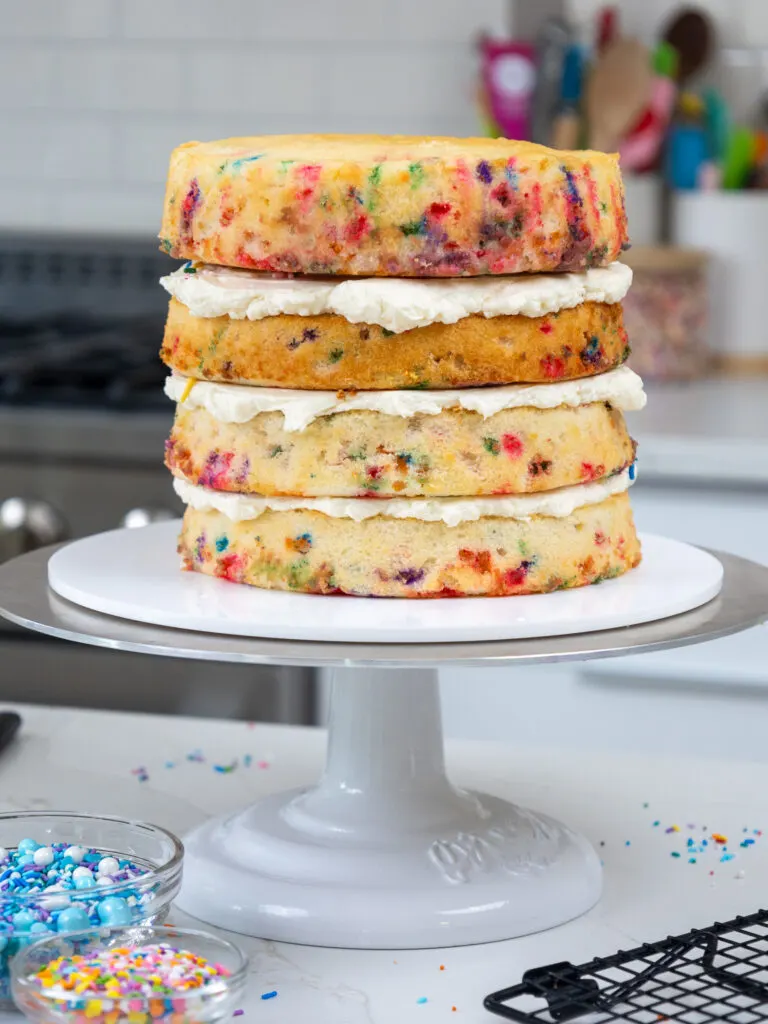 image of funfetti cake layers that have been stacked and are ready to be crumb coated