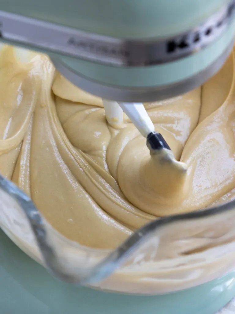 image of brown sugar cake batter that's being mixed in a kitchen aid stand mixer