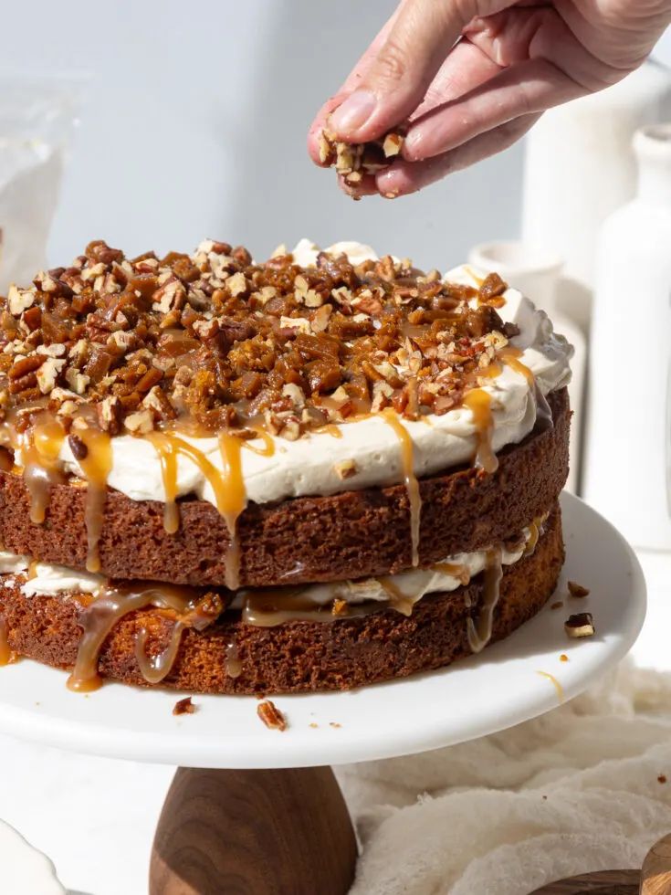 image of toffee bits being added to a cake filling