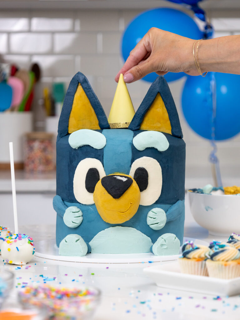 image of a bluey birthday cake that's been made with buttercream and sprinkle cake layers