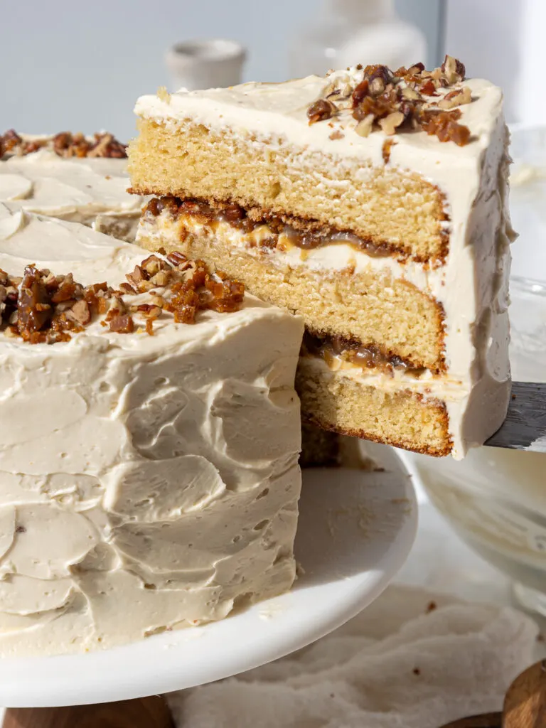 image of a slice being pulled from a butterscotch crunch cake