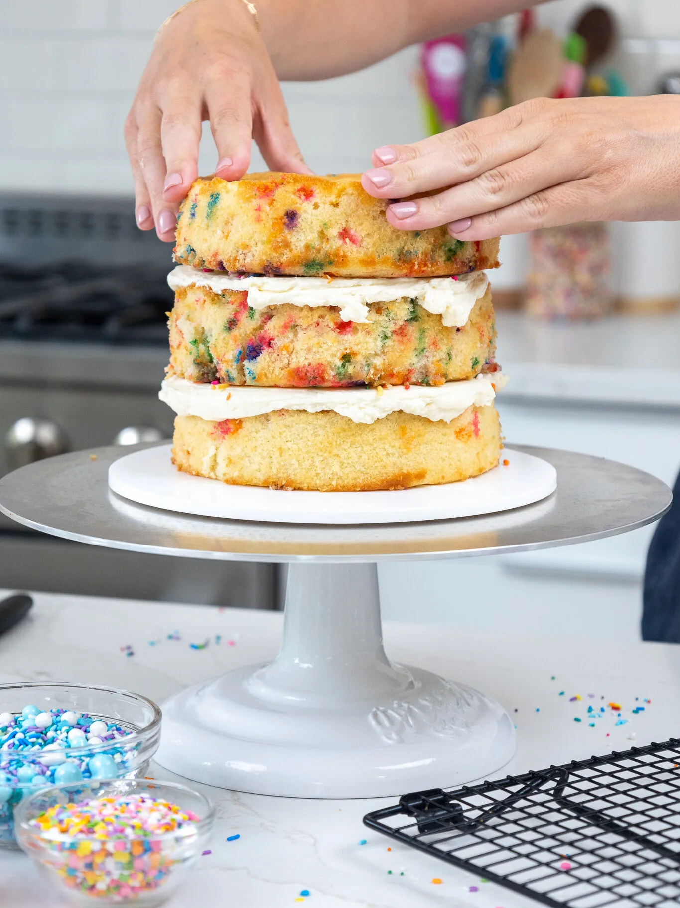 image of funfetti cake layers being stacked