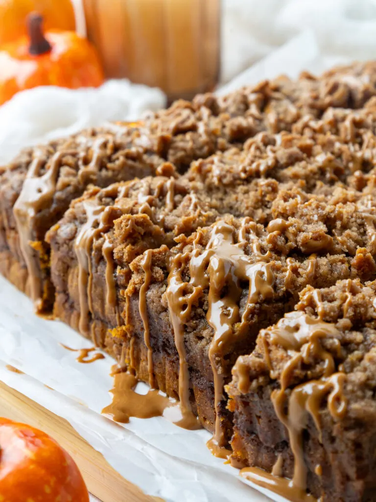 image pumpkin coffee cake that's been topped with streusel and cookie butter