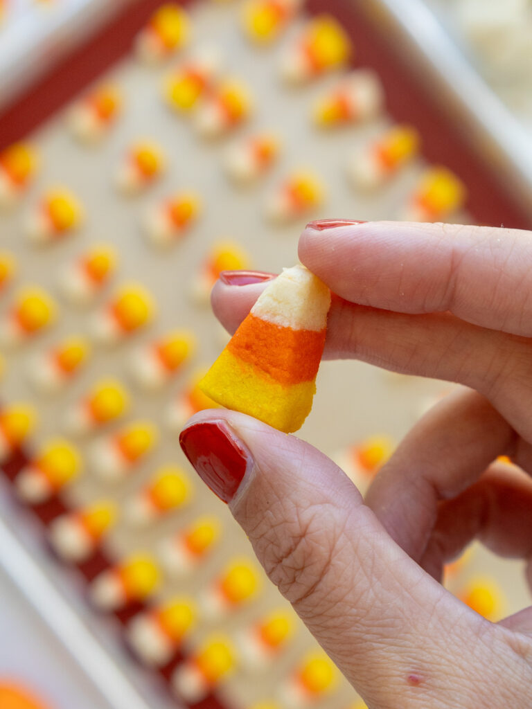 image of a candy corn cookie being held up to show how small it is