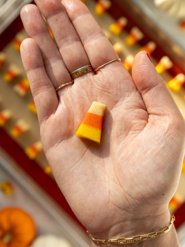 image of a candy corn cookie being held up to show how small it is