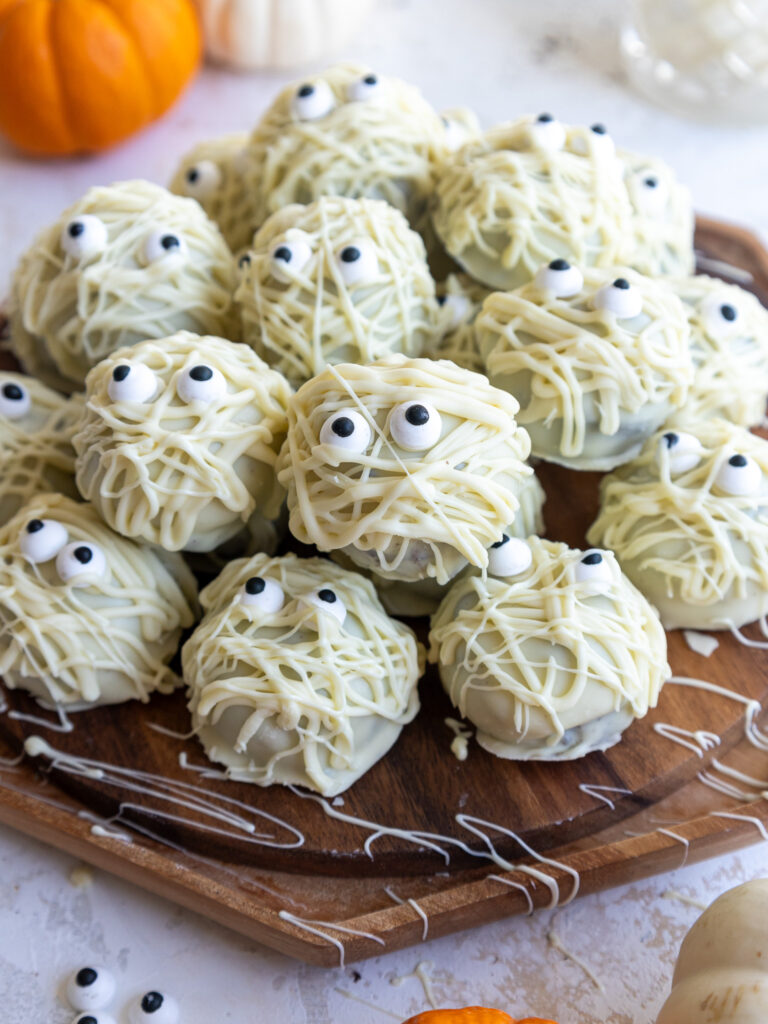 image of mummy cake pops set on a wooden platter