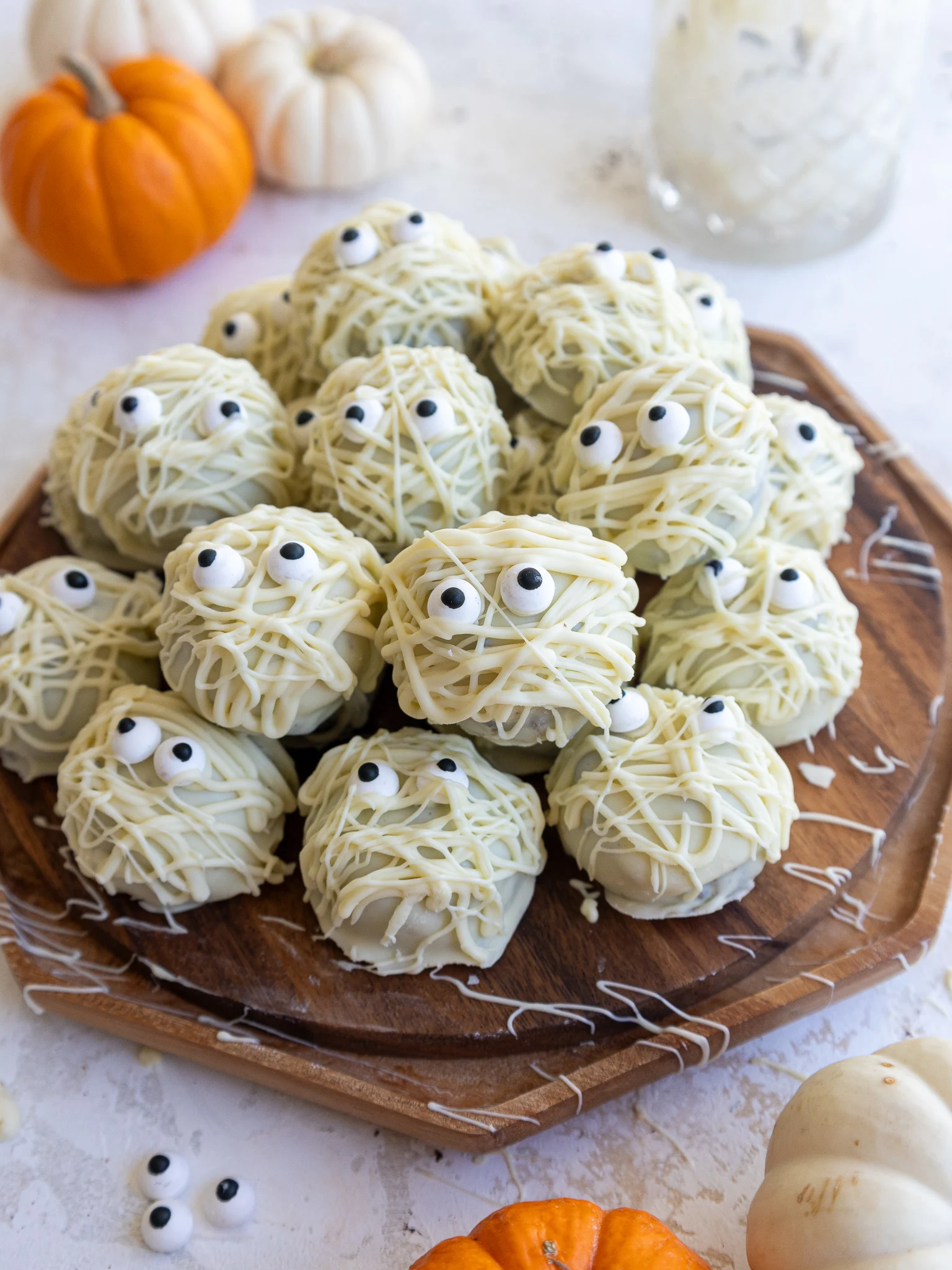 image of mummy cake pops set on a wooden platter