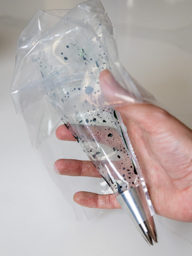 
image of a piping bag being brushed with gel food coloring