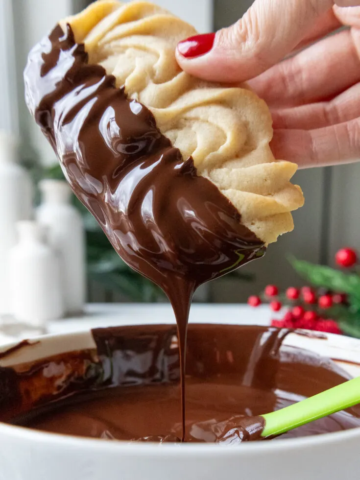 image of a butter cookie being dipped in chocolate