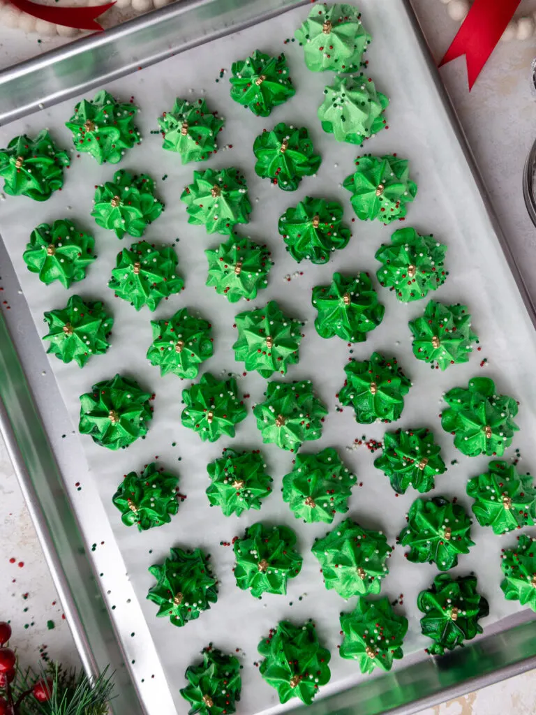 image of meringue trees that are cooling on baking sheet