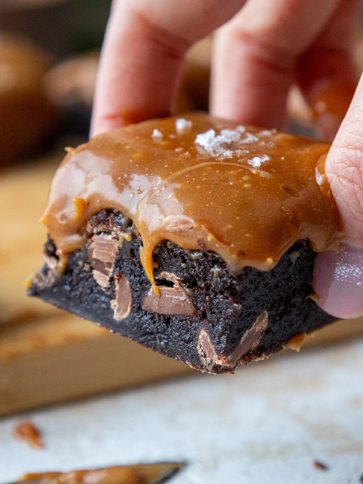 image of a caramel brownie that's been cut into to show its gooey caramel topping