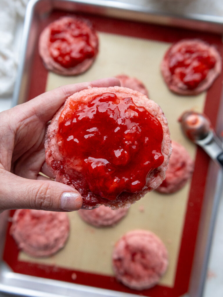 image of a strawberry sugar cookie that's been topped with a strawberry reduction