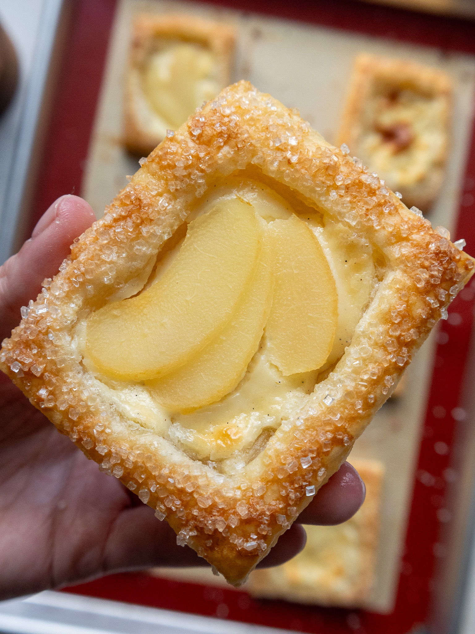 image of a cream cheese puff pastry that's been topped with sliced pears