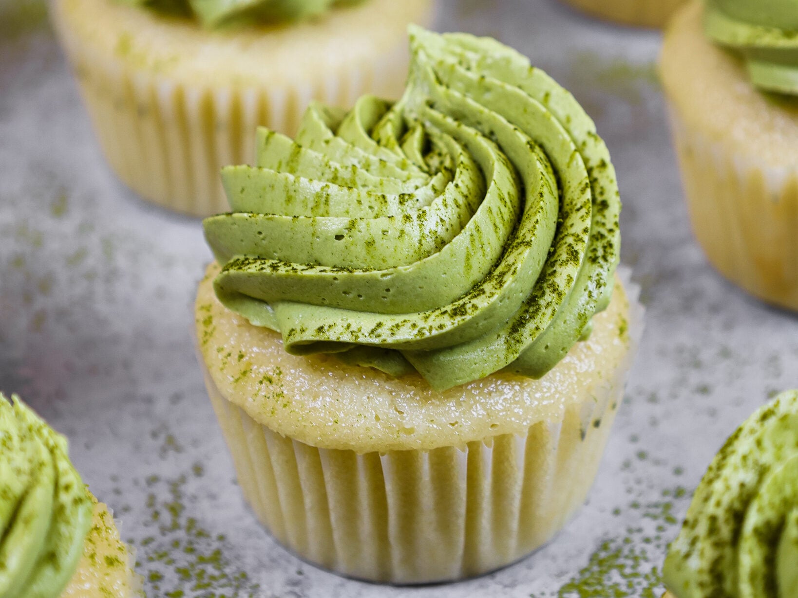 image of matcha cupcakes topped with a not too sweet matcha buttercream