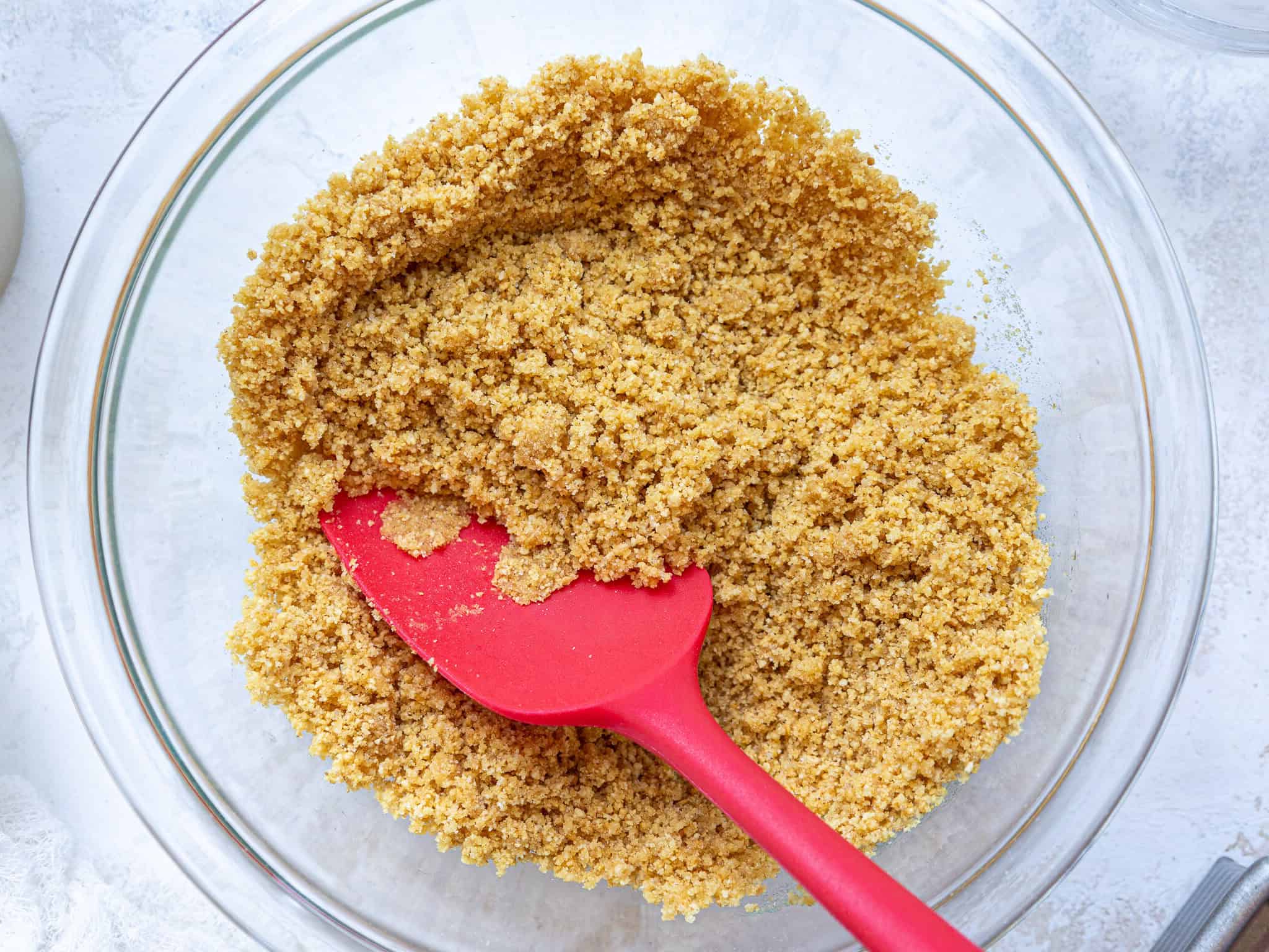 image of graham cracker crumbs mixed with butter to make a graham cracker crust