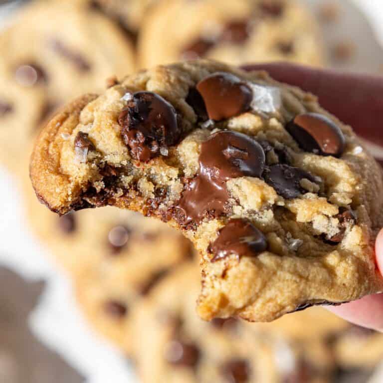image of a chewy chocolate chip cookie that's been bitten into to show how soft it is
