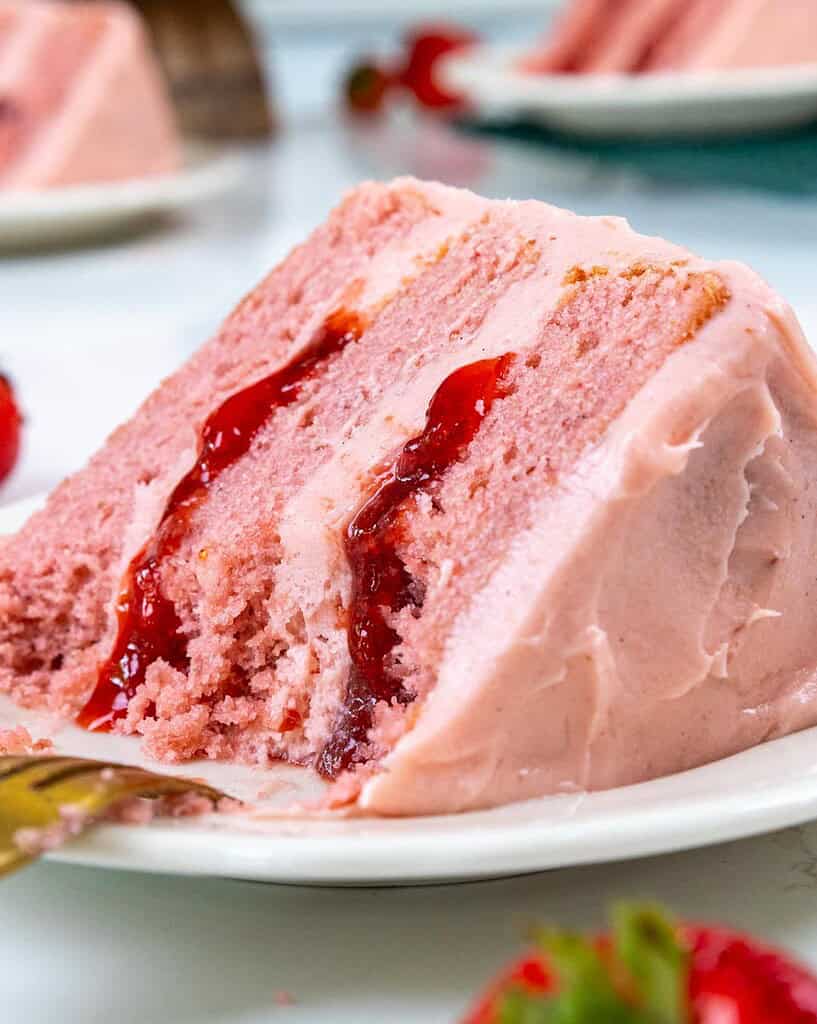 image of a strawberry cake made with strawberry filling and strawberry cream cheese frosting