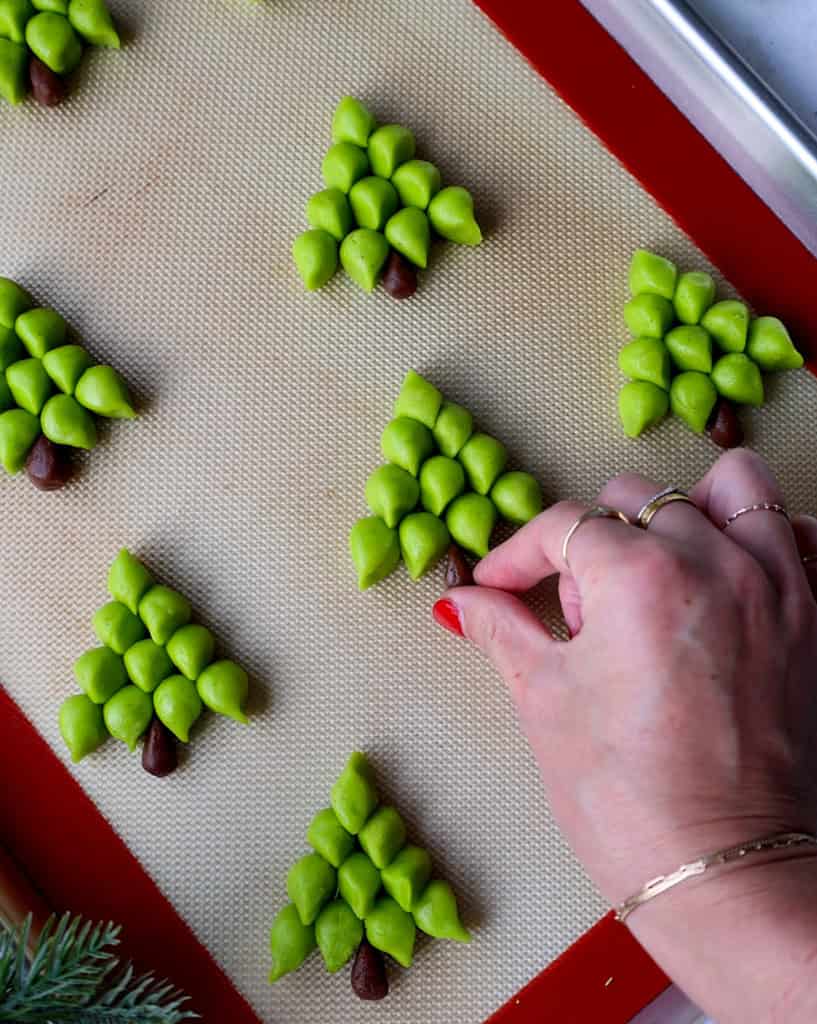 adding a cookie dough stem to Christmas tree cookies