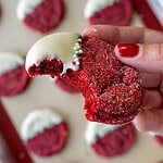 image of a red velvet sugar cookie that's been dipped in white chocolate