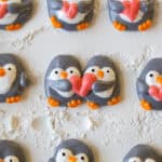 image of penguin marshmallows that have been piped on a baking sheet