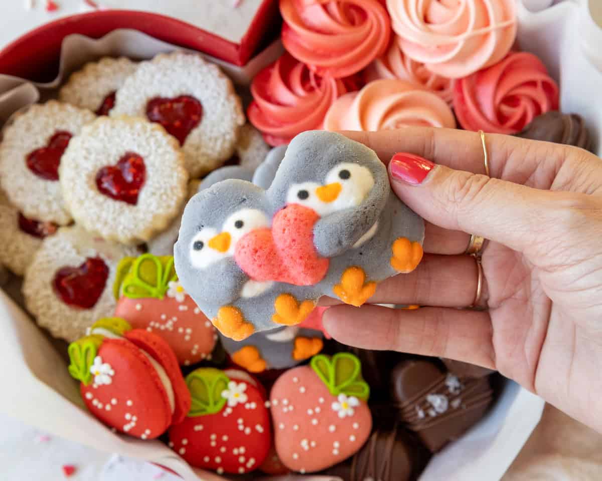 image of cute penguin marshmallows holding a heart