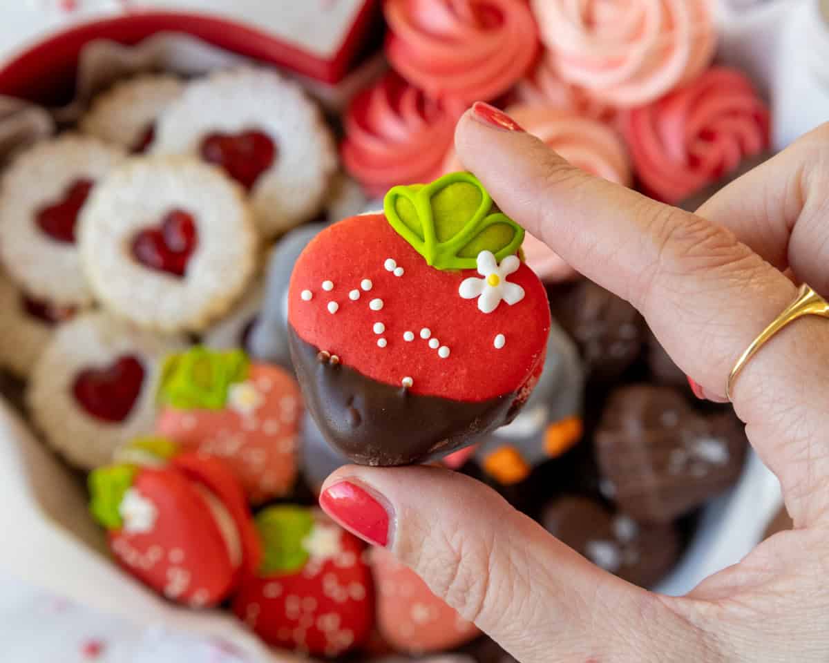 image of a chocolate dipped strawberry macaron