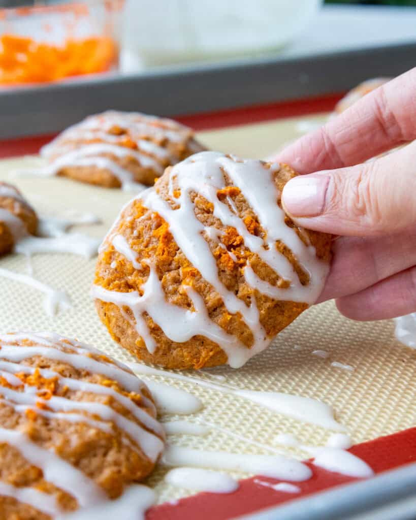 image of a carrot cake cookie that's been drizzled with a cream cheese glaze