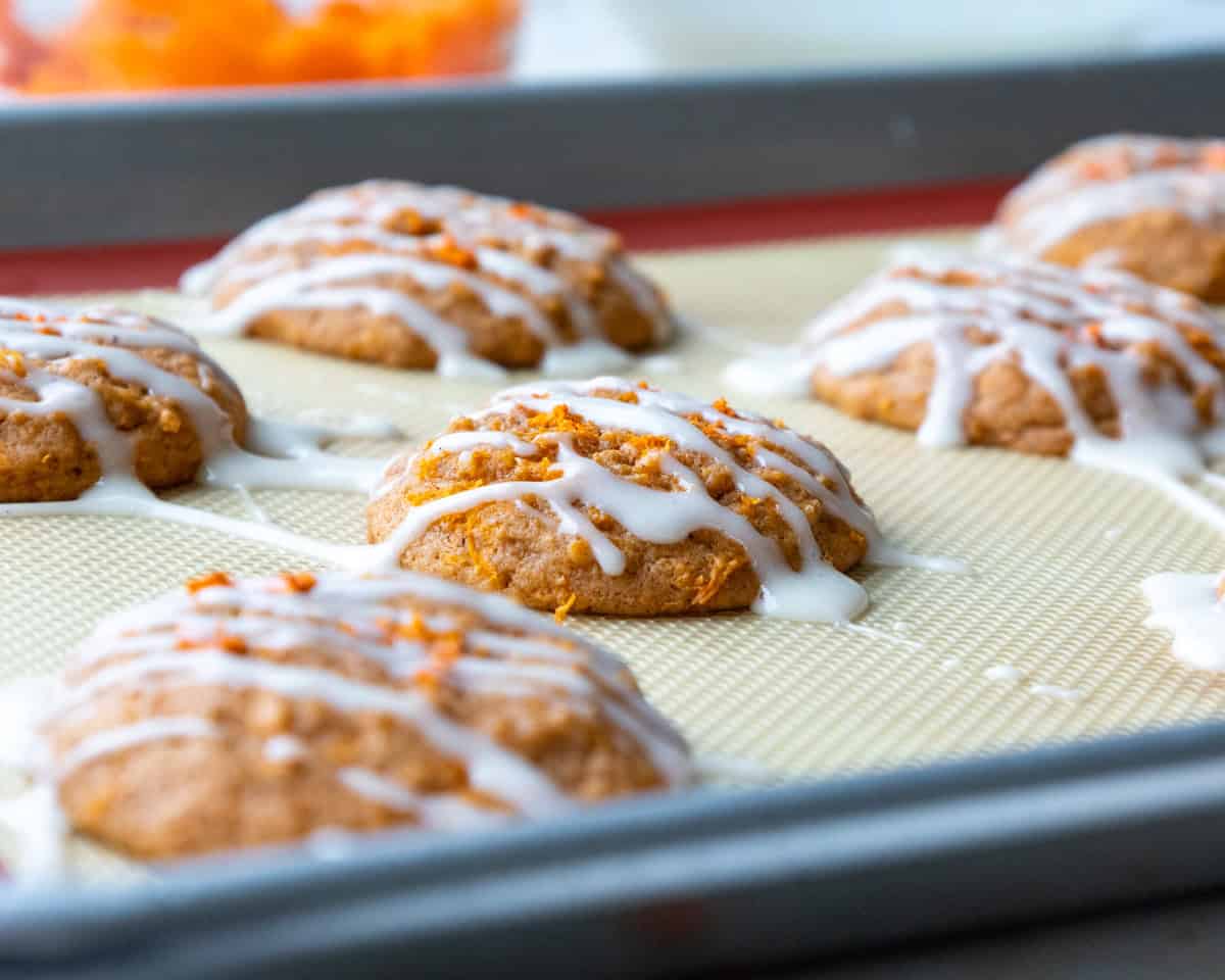 image of a carrot cake cookie that's been drizzled with a cream cheese glaze