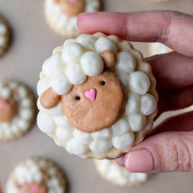 image of a cute easter sheep cookie that's been decorated with buttercream