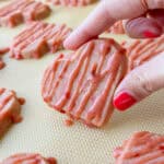 image of strawberry shortbread cookies that have been drizzled with a strawberry glaze