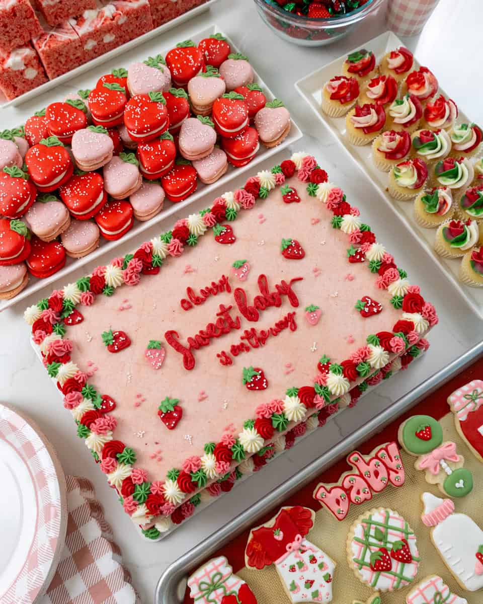 image of berry themed baby shower desserts that have been set out