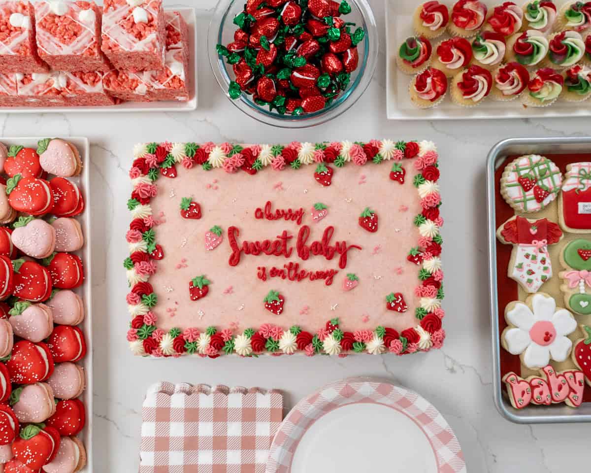 image of berry themed baby shower desserts that have been set out