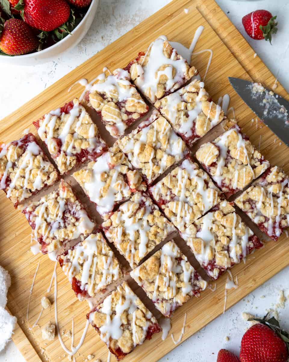 image of strawberry crumble bars that have been drizzled with strawberry glaze