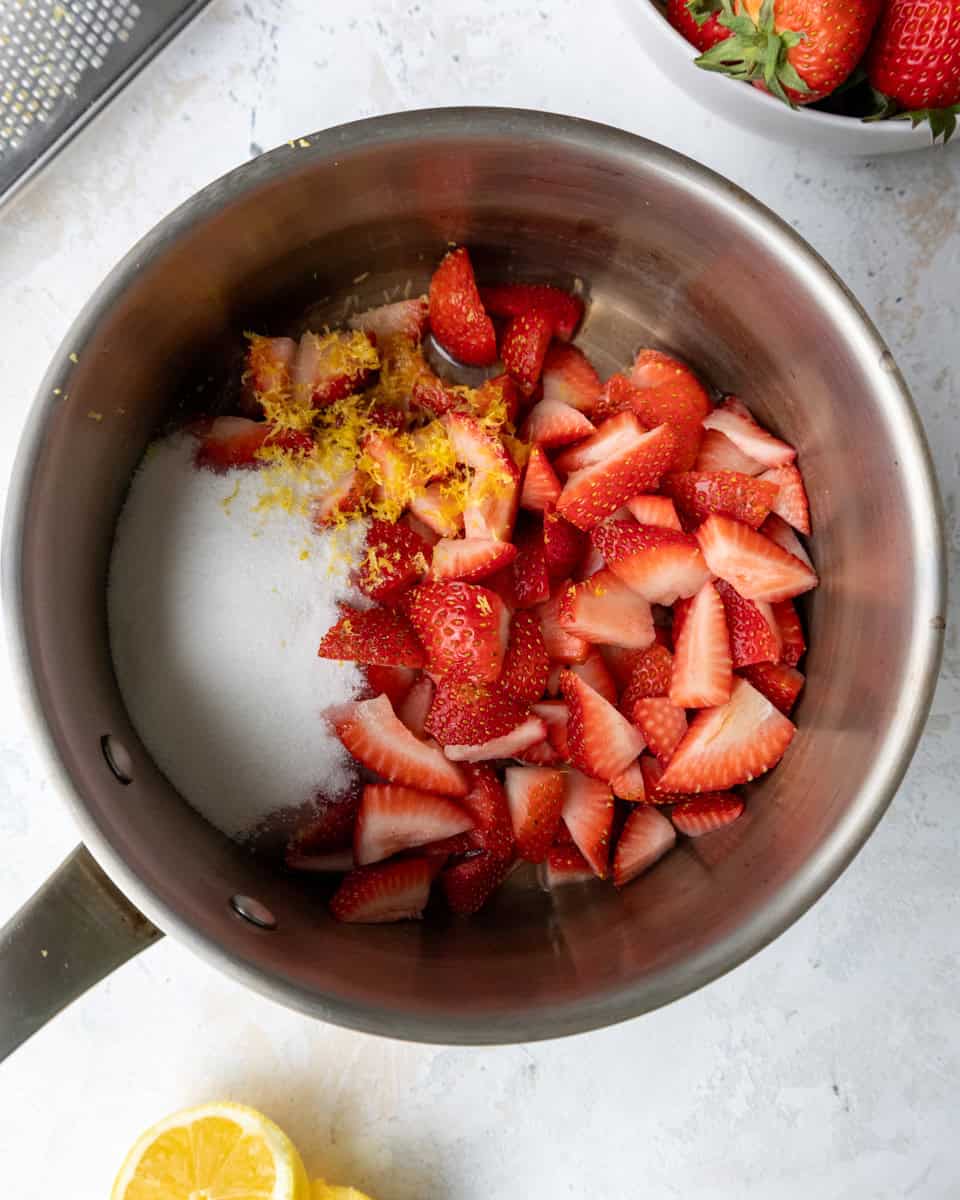 image of ingredients in a pan to make a strawberry filling for strawberry crumble bars