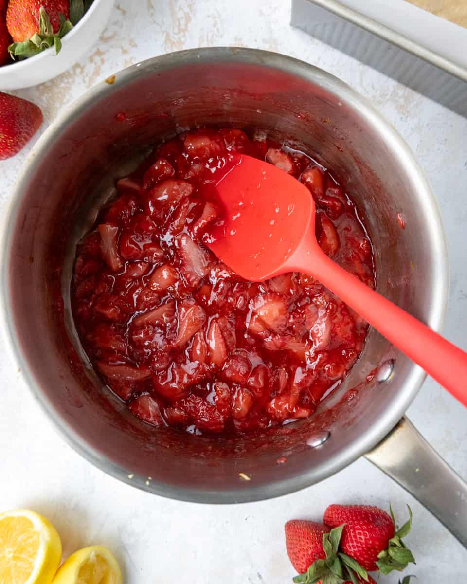 image of strawberry filling for strawberry crumble bars being cooked down in a saucepan