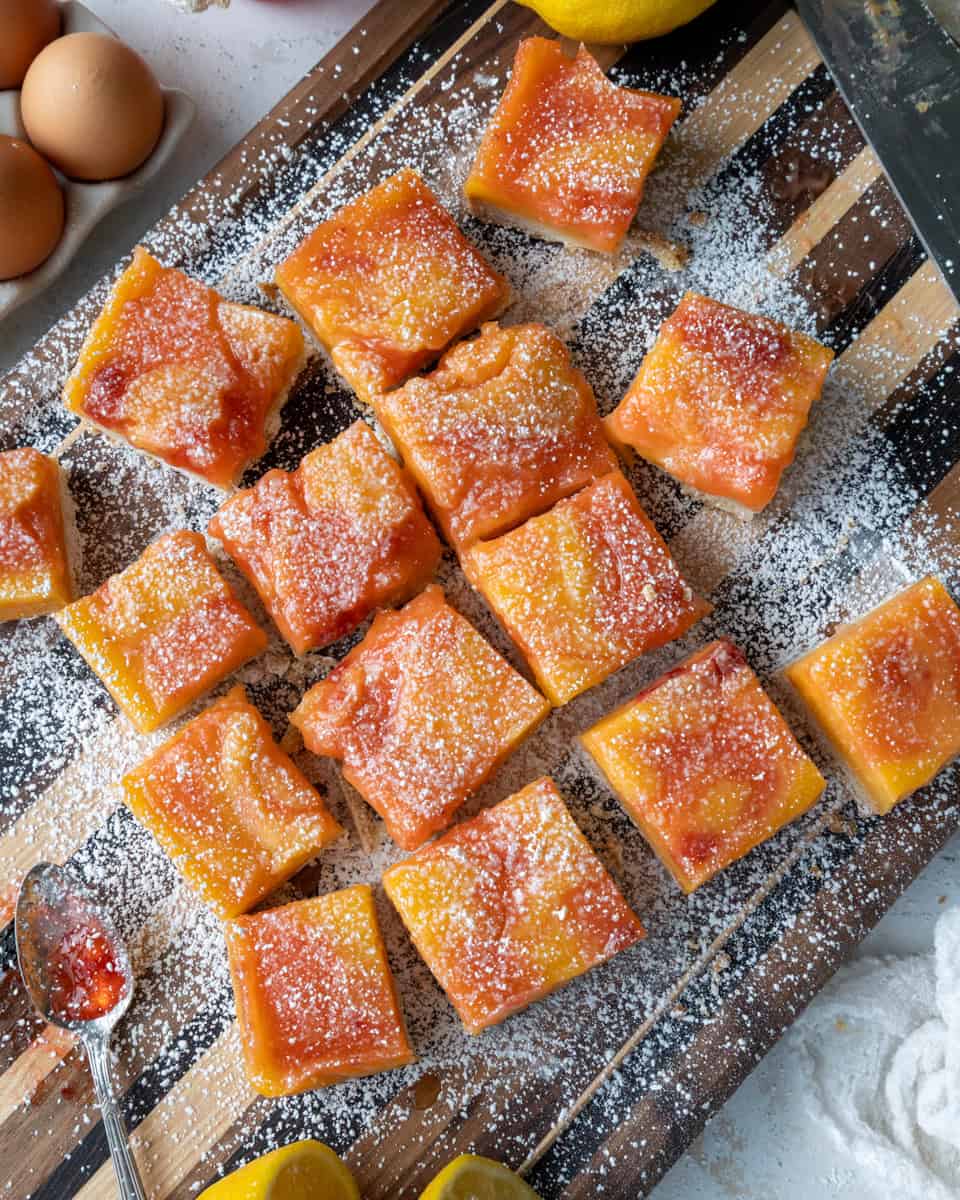 image of strawberry lemon bars that have been dusted with powdered sugar and have been cut