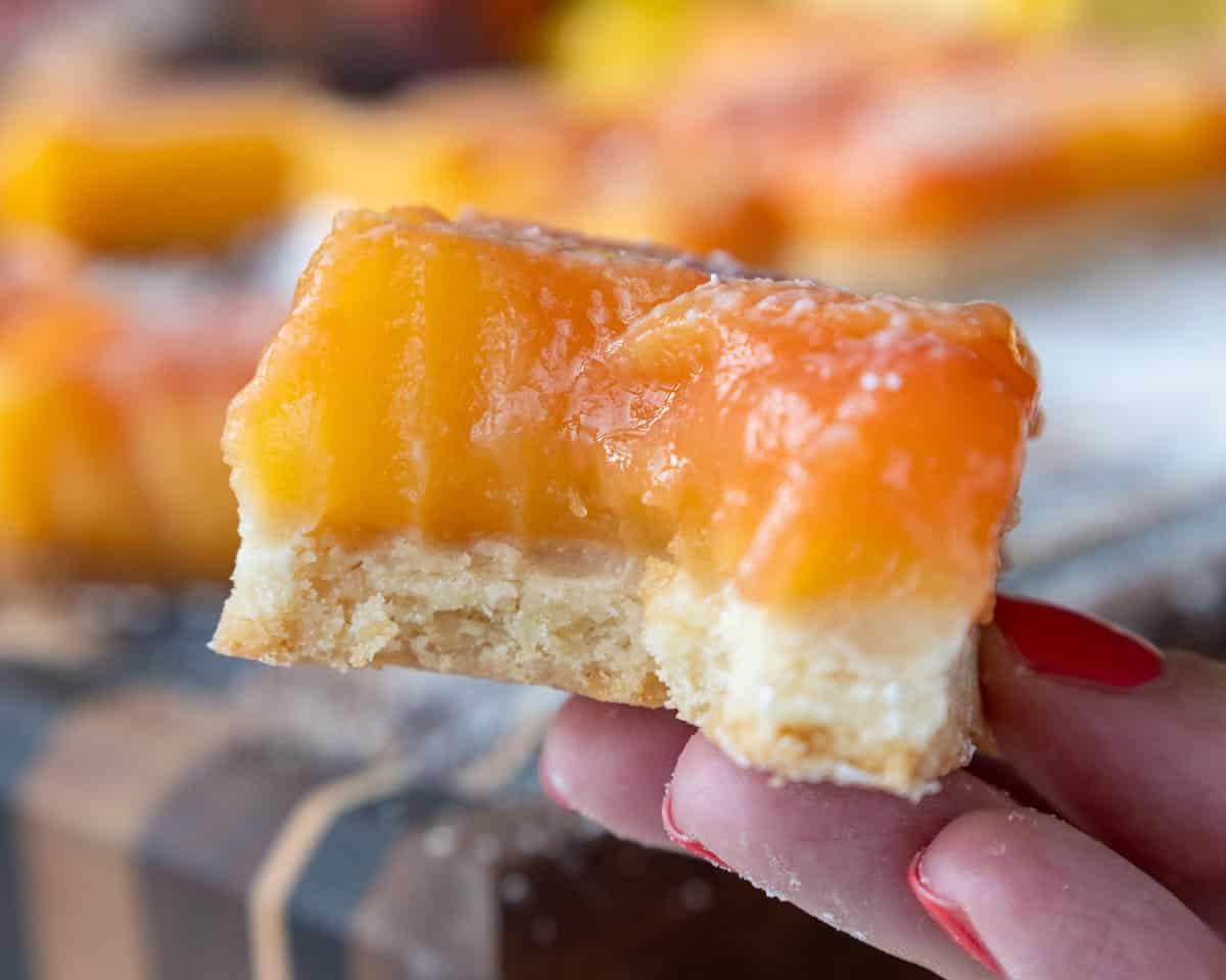 image of a strawberry swirled lemon bar that's been bitten into