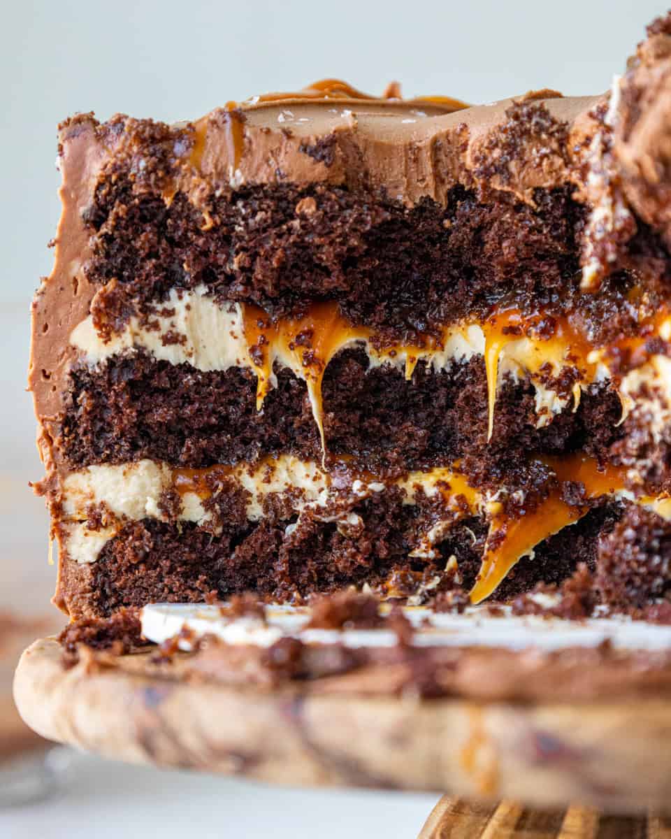 image of a chocolate and salted caramel cake that's been cut into to show its layers