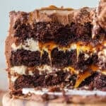image of a chocolate and salted caramel cake that's been cut into to show its layers