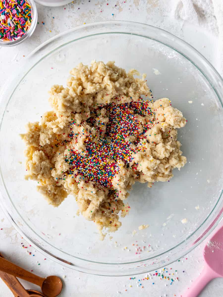 image of sprinkles being added to shortbread cookie dough