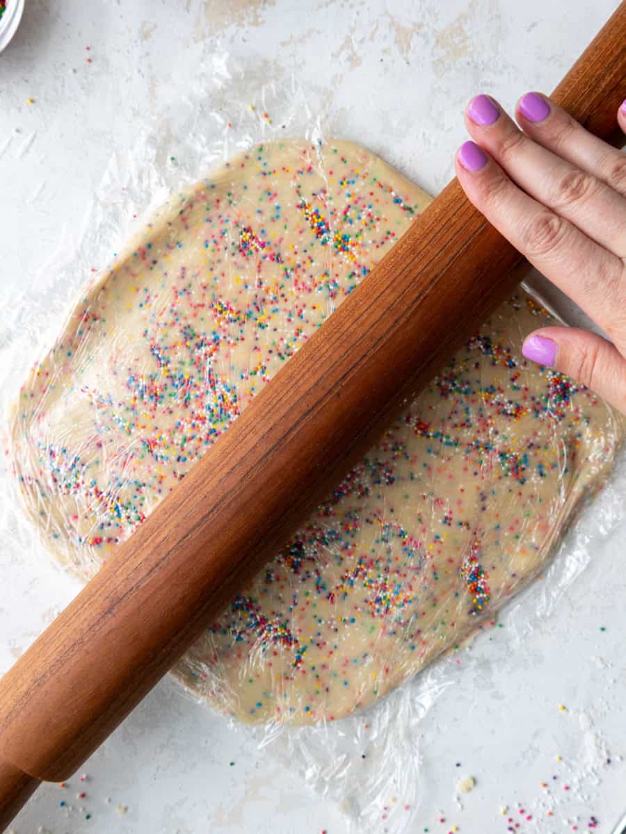 image of funfetti shortbread cookie dough being rolled out to be chilled