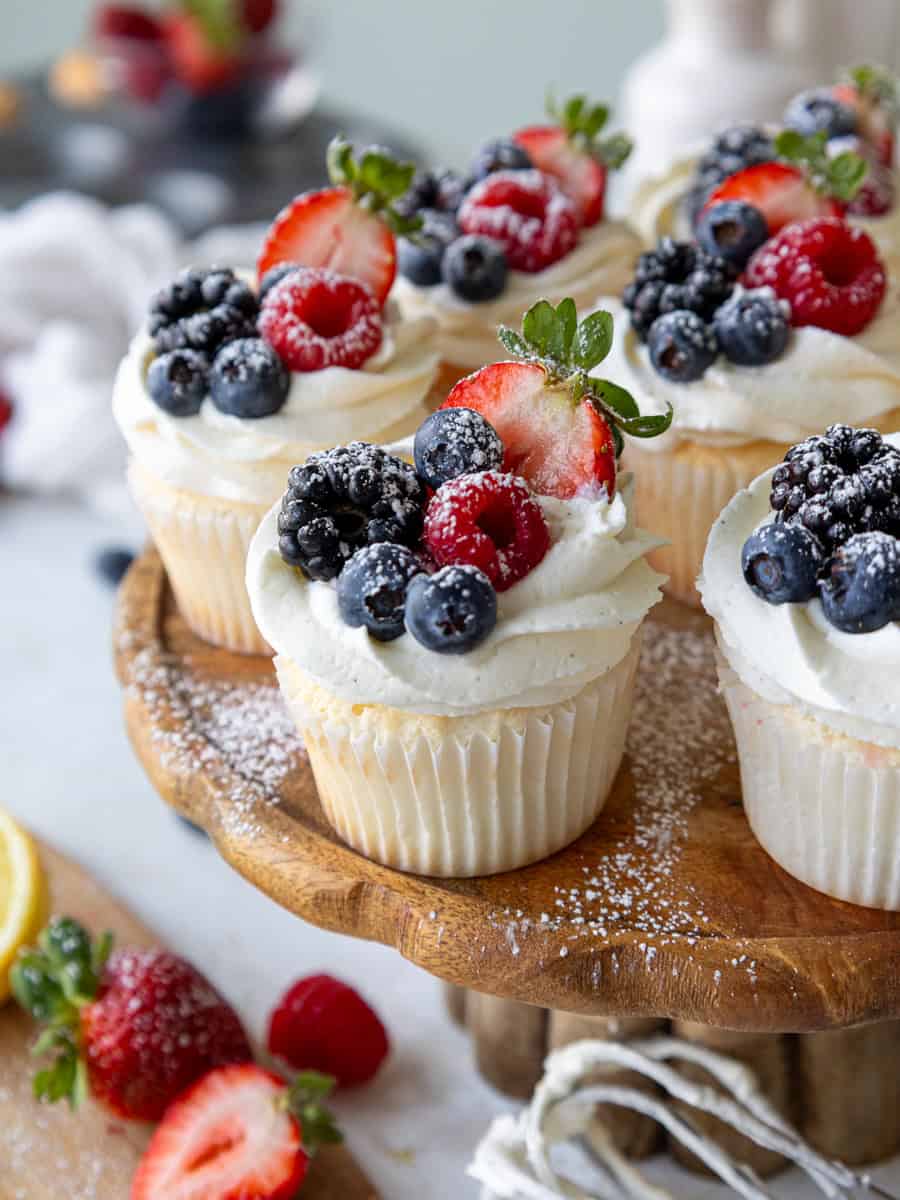 image of angel food cake cupcakes decorated with fresh berries and a dusting of powdered sugar