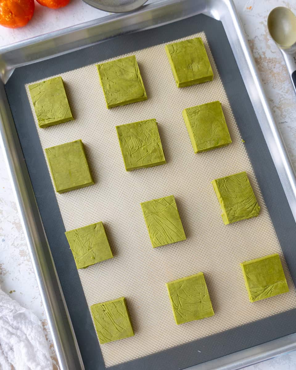 image of matcha shortbread cookie dough that's been cut to make Frankenstein cookies