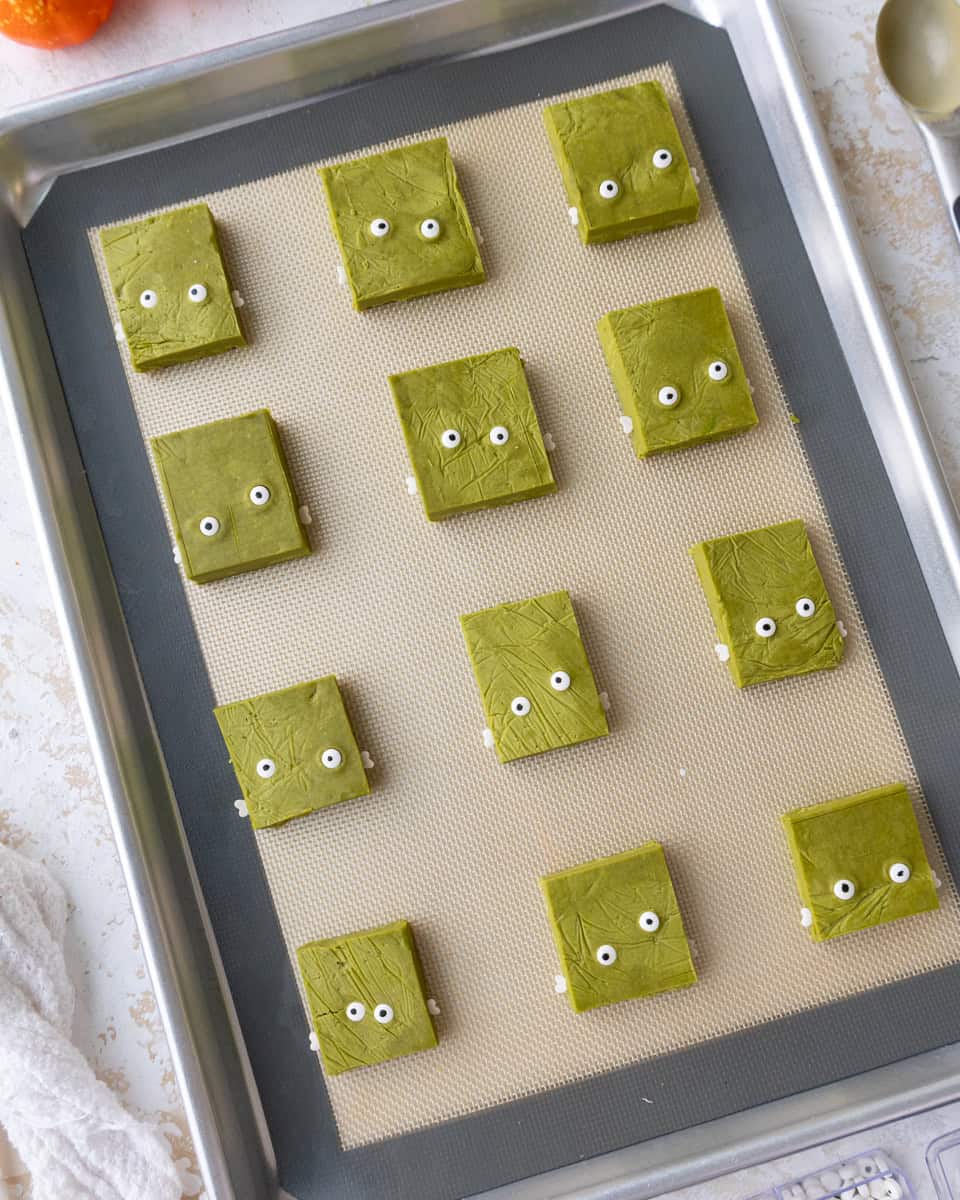 image of matcha shortbread cookie dough that's been decorated to make Frankenstein cookies