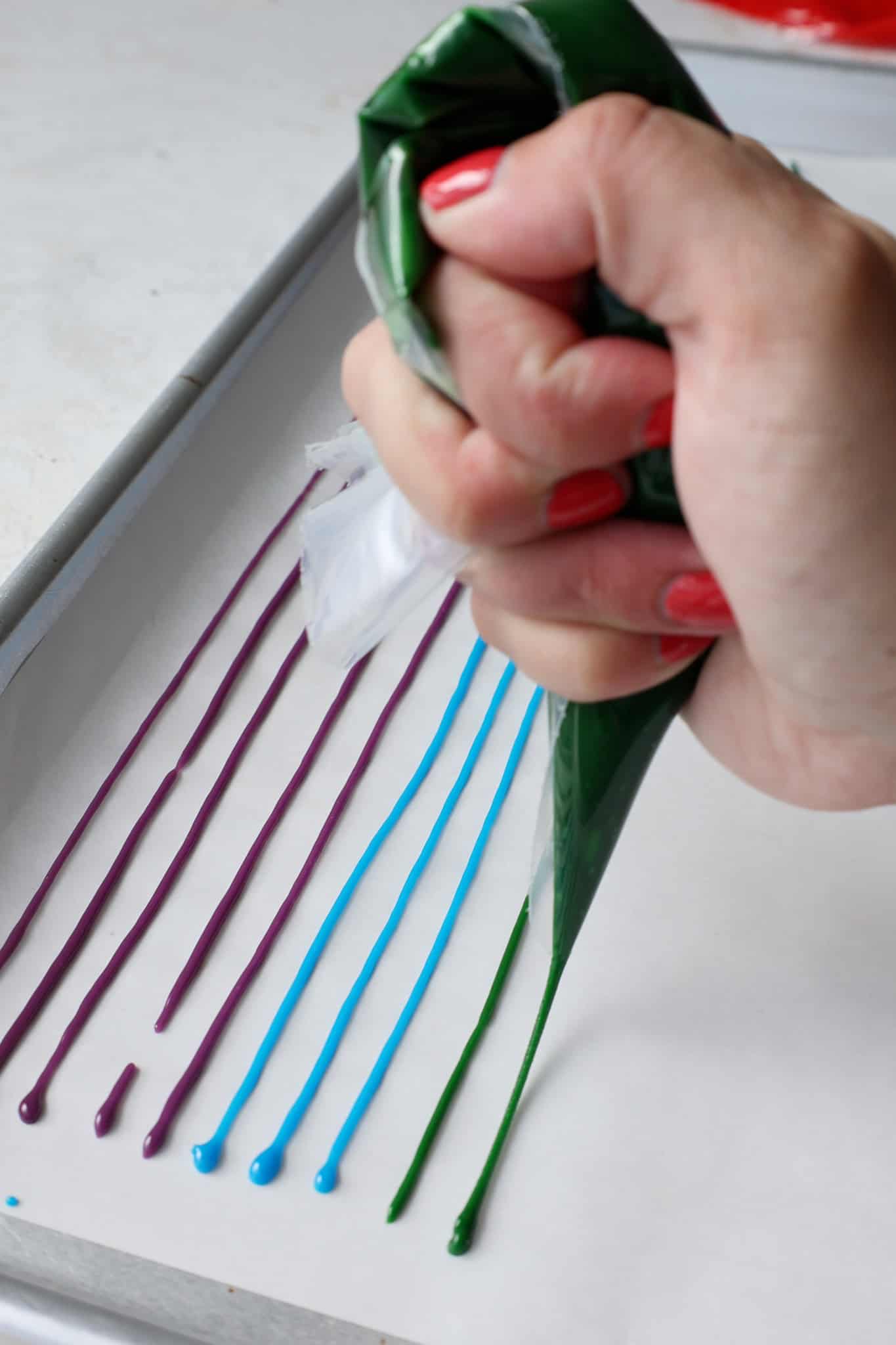 image of homemade sprinkle batter being piped onto a lined baking sheet