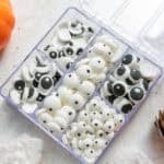 image of homemade candy eyes that have been sorted into a plastic container