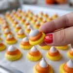 image of candy corn meringues that have been baked and are cooling on a baking sheet