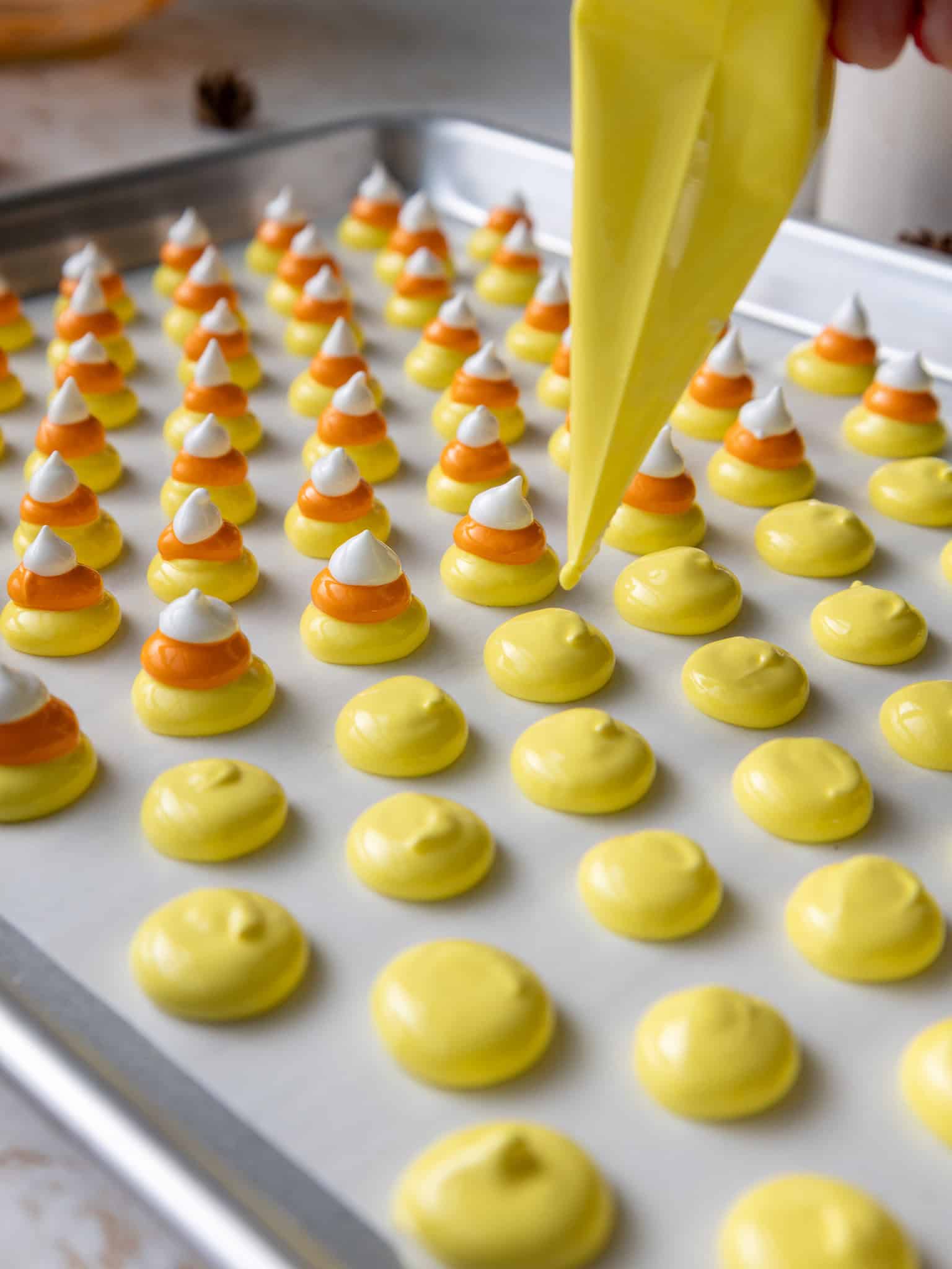 image of candy corn meringues being piped